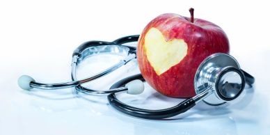Apple with heart shape and stethoscope